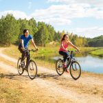 couple biking near river