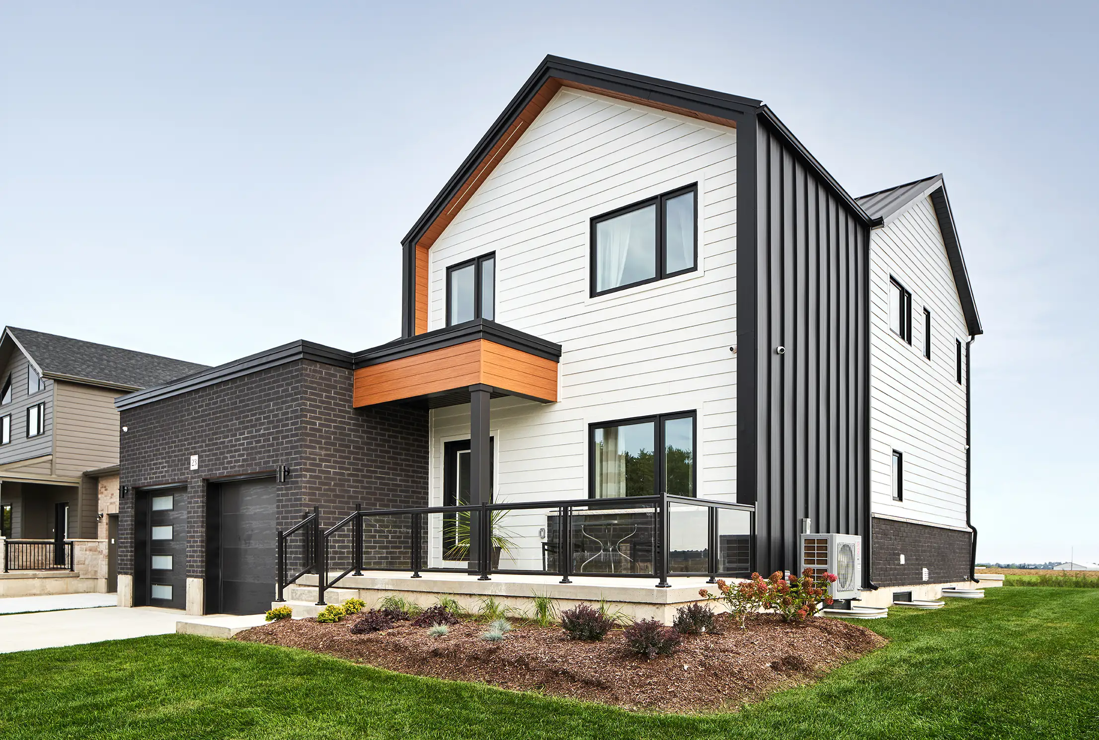 Two-storey white and black home with an attached garage
