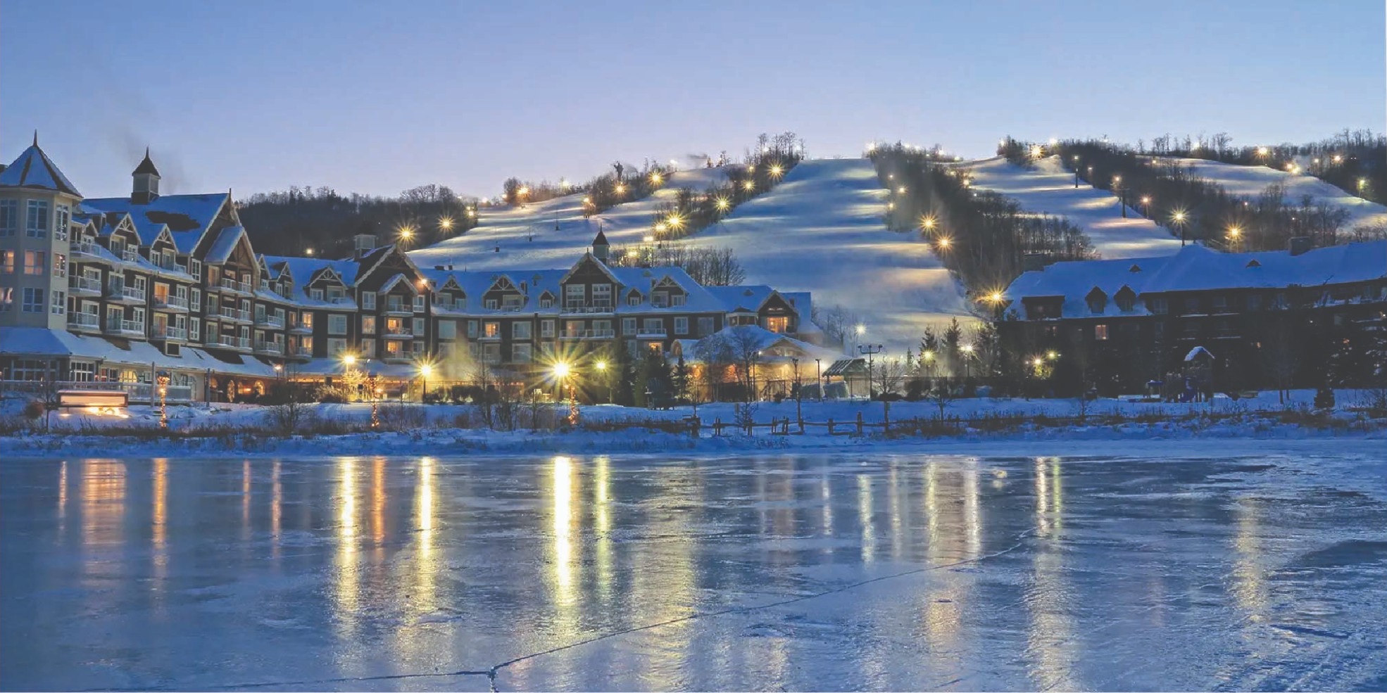 Blue Mountain village and lit ski hills on a winter evening
