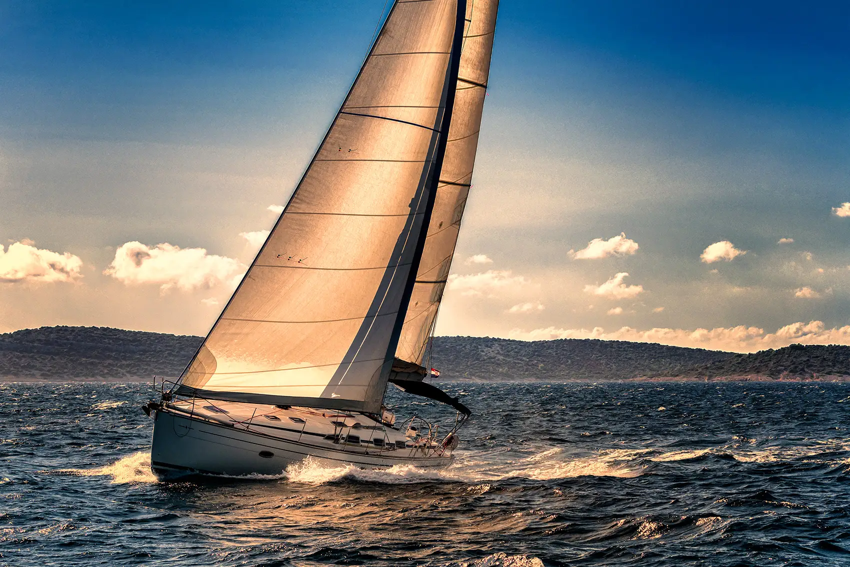 Sailboat heeling on Georgian Bay at sunset