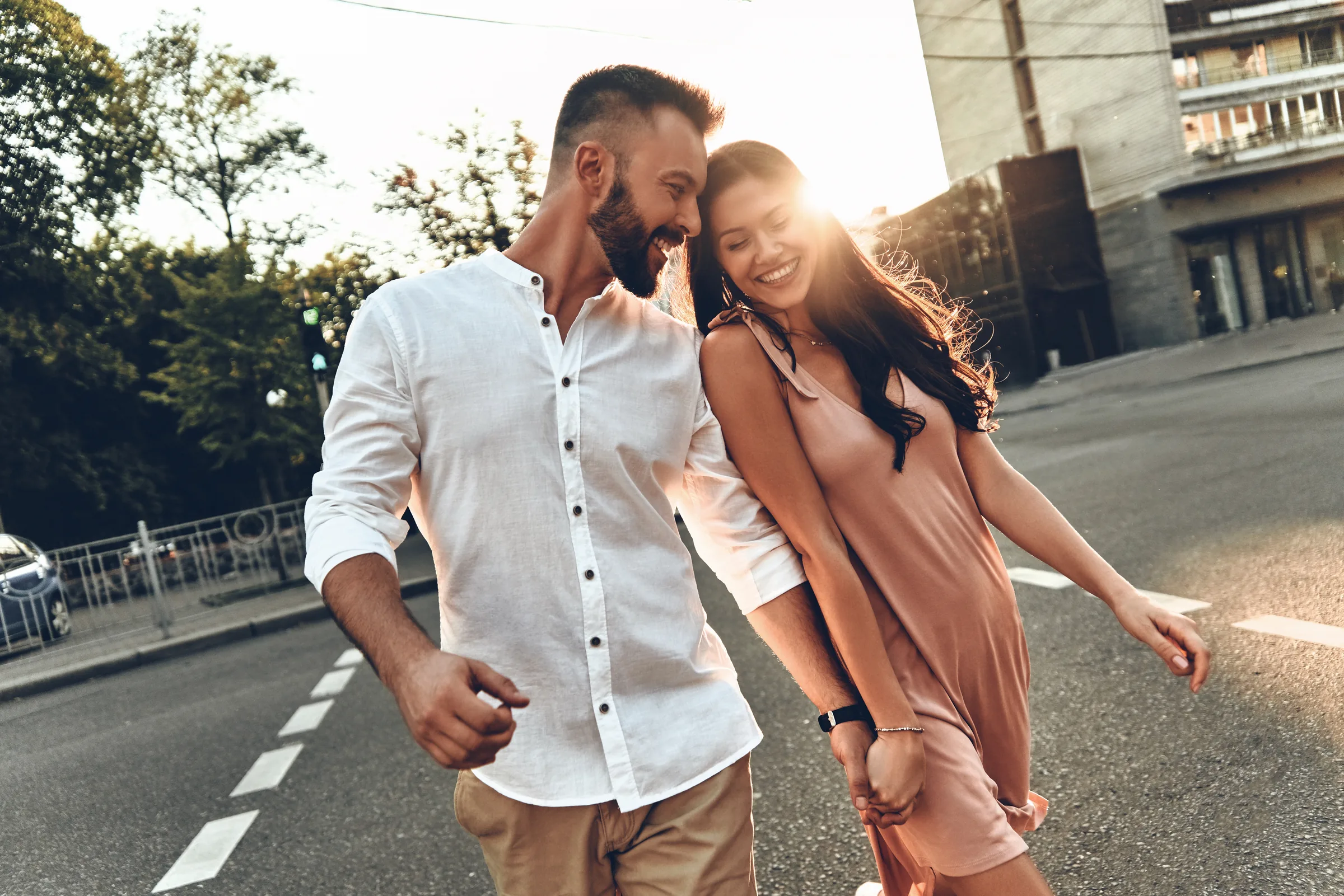 Couple walking arm in arm through town