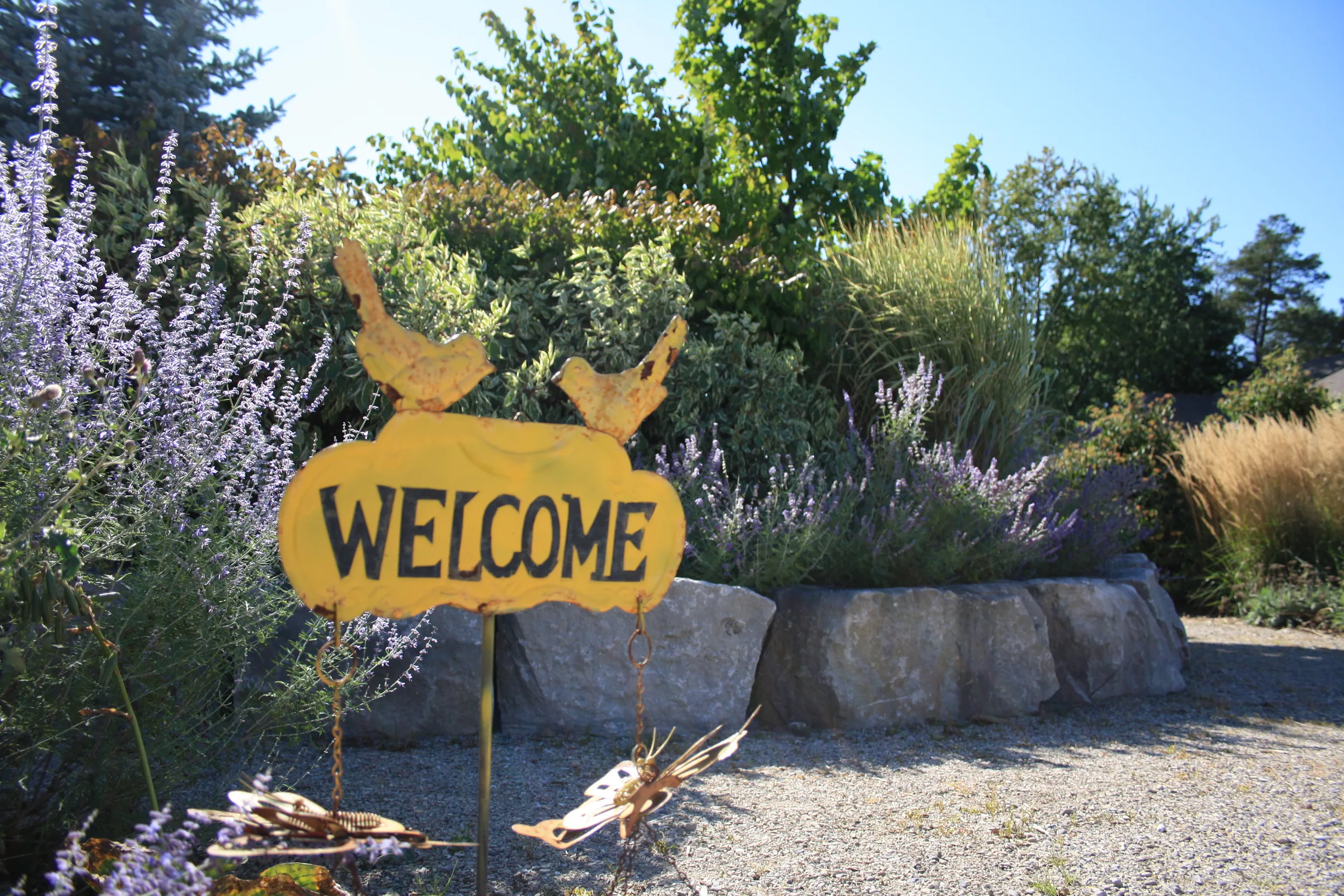 Embro welcome sign in a garden of lavender and grasses