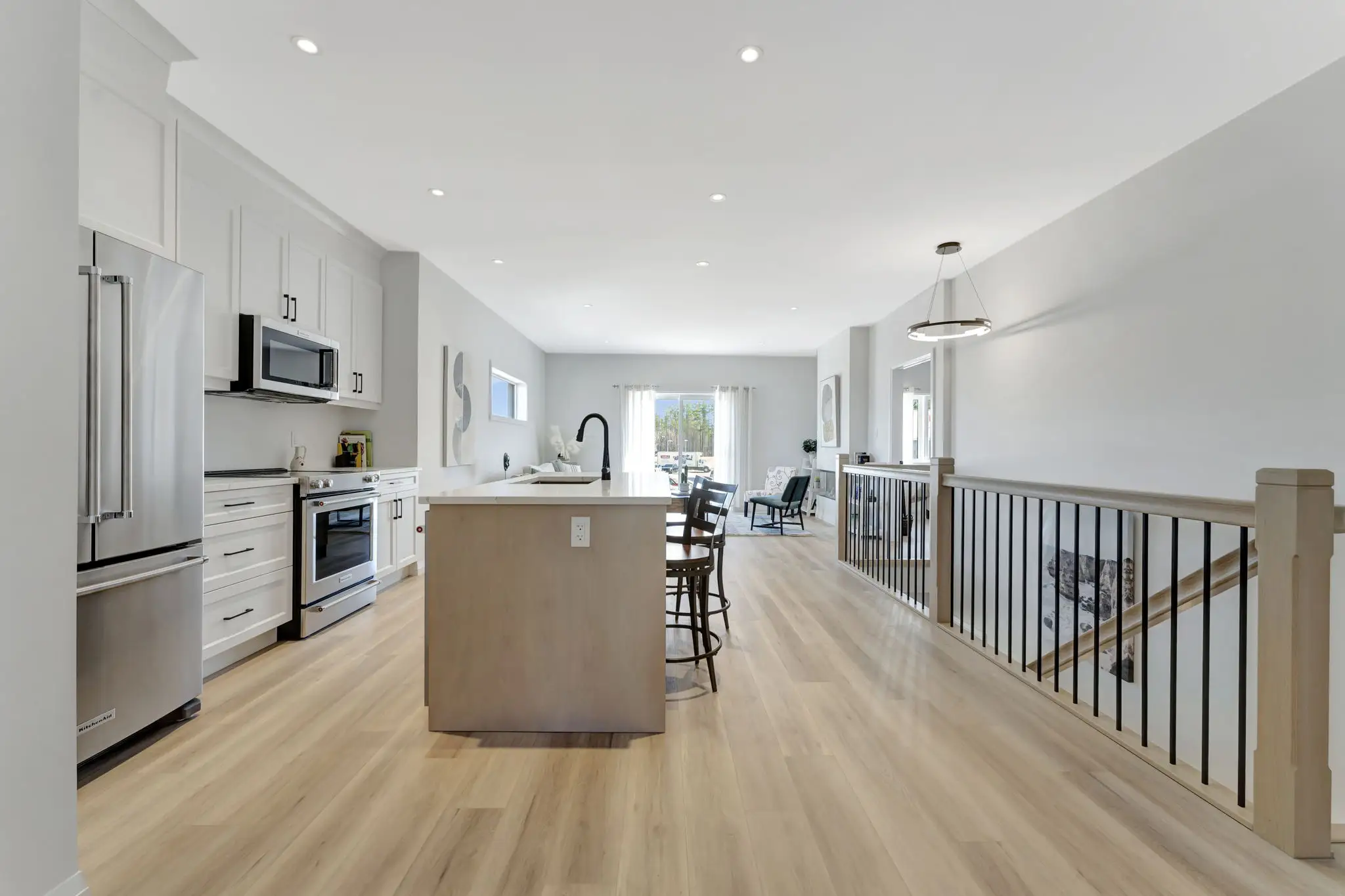 Bright kitchen beside the loft railing in a Nestings bungalow loft