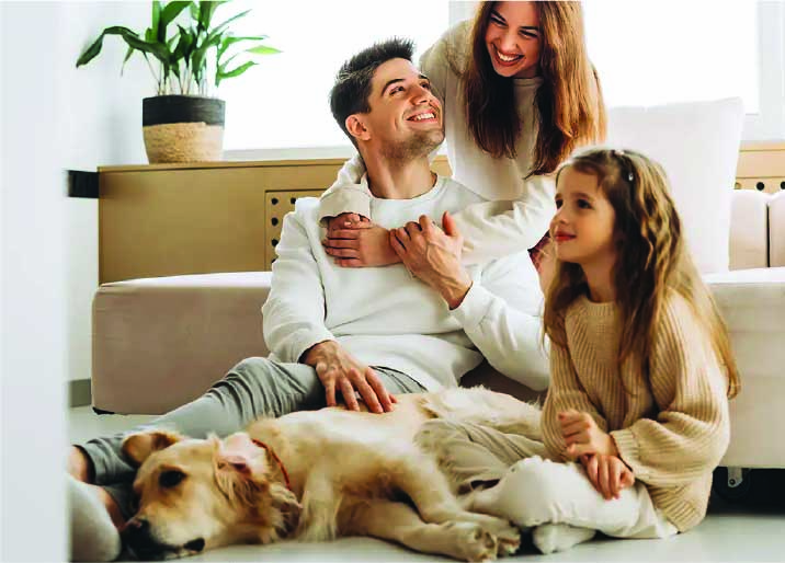 Family relaxing at home with their dog